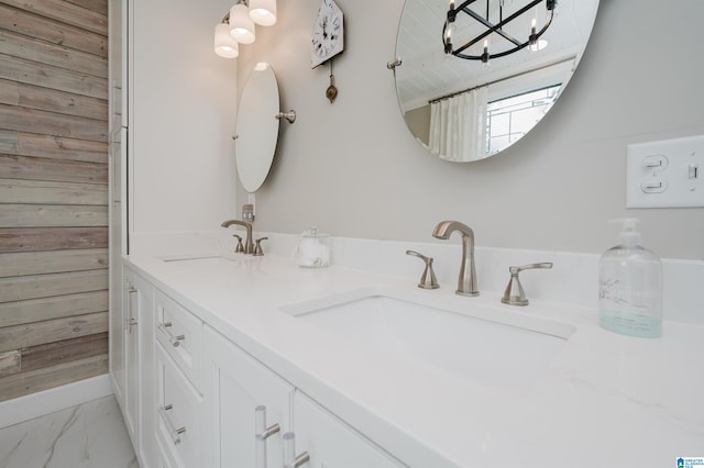 477 Seales Rd, Helena, AL 35022 - full bathroom featuring wood walls, a notable chandelier, marble finish floor, and a sink