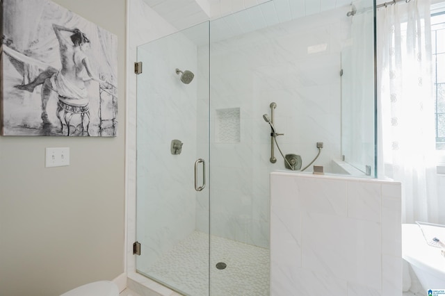 bathroom with toilet and a shower with shower door