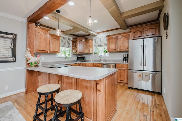 kitchen with light wood-type flooring, beam ceiling, kitchen peninsula, a kitchen bar, and appliances with stainless steel finishes