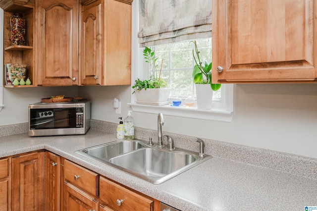 477 Seales Rd, Helena, AL 35022 - kitchen with stainless steel microwave, brown cabinets, light countertops, and a sink