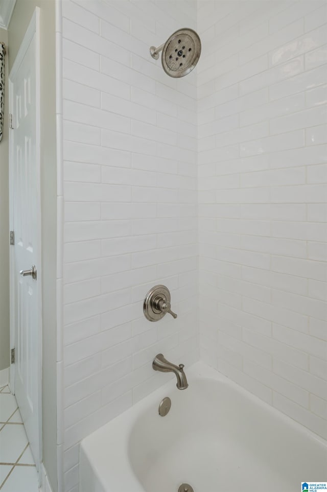 bathroom with tiled shower / bath combo and tile patterned flooring