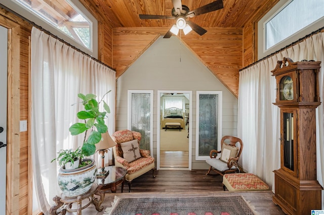 living area featuring wood ceiling, wood walls, ceiling fan, and dark hardwood / wood-style flooring