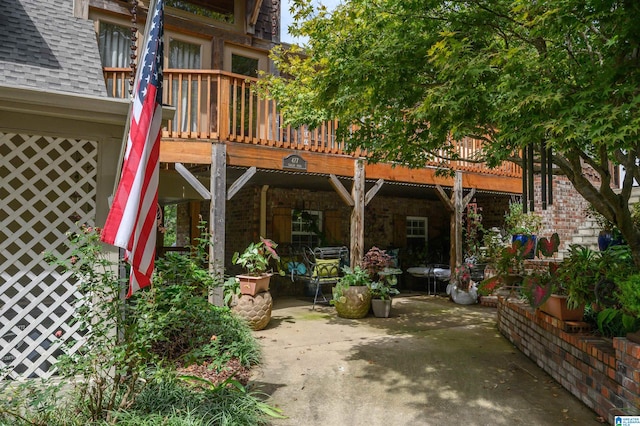 back of house with a balcony and a patio