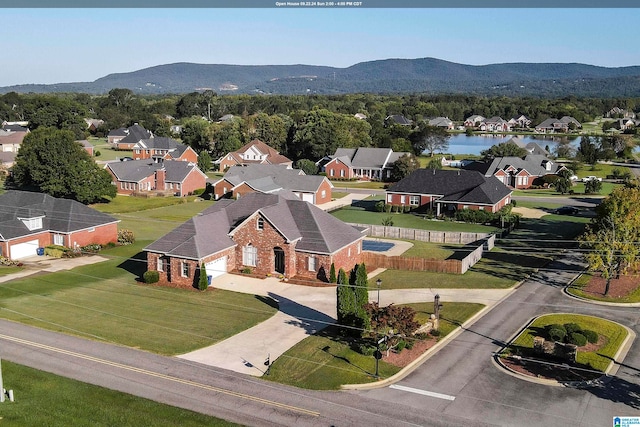 drone / aerial view with a water and mountain view