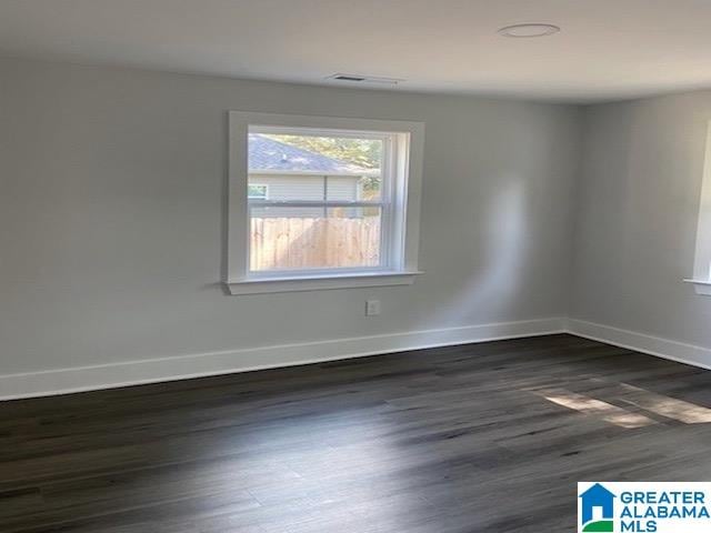 empty room featuring dark wood-type flooring