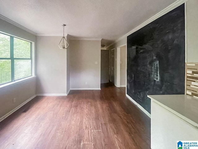 interior space with ornamental molding, a textured ceiling, and dark hardwood / wood-style flooring