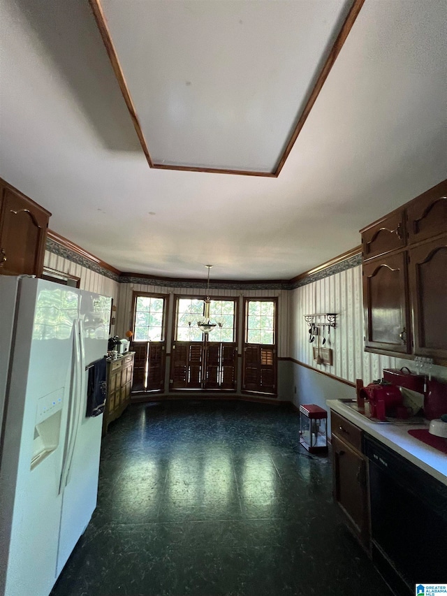 kitchen with hanging light fixtures, black dishwasher, white fridge with ice dispenser, and dark brown cabinetry