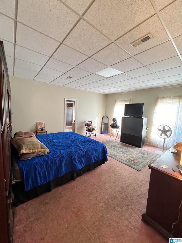 carpeted bedroom featuring a paneled ceiling