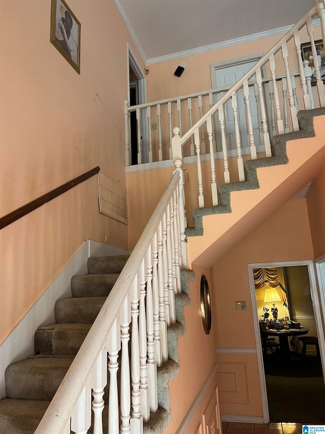 stairway featuring crown molding