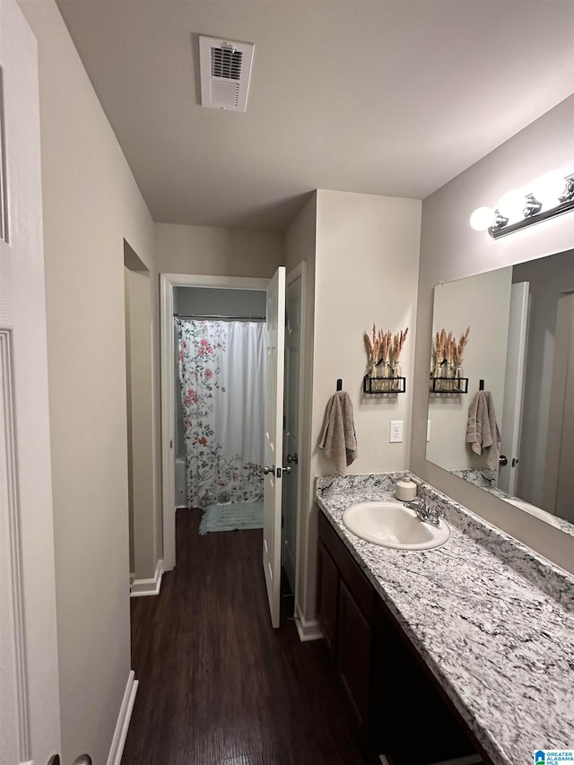 bathroom featuring hardwood / wood-style floors, vanity, and a shower with curtain