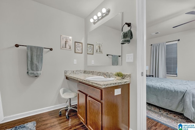 bathroom with wood-type flooring, vanity, and ceiling fan