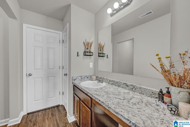 bathroom featuring hardwood / wood-style floors and vanity