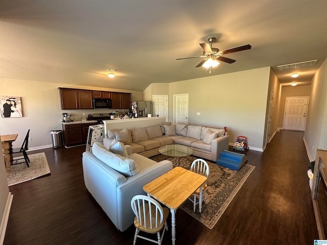 living room with ceiling fan and dark wood-type flooring