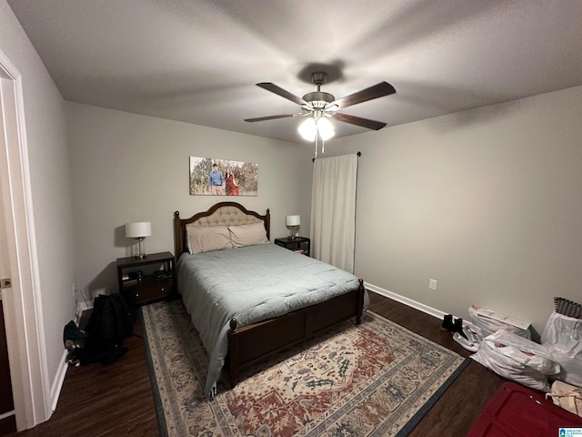 bedroom with ceiling fan and dark wood-type flooring