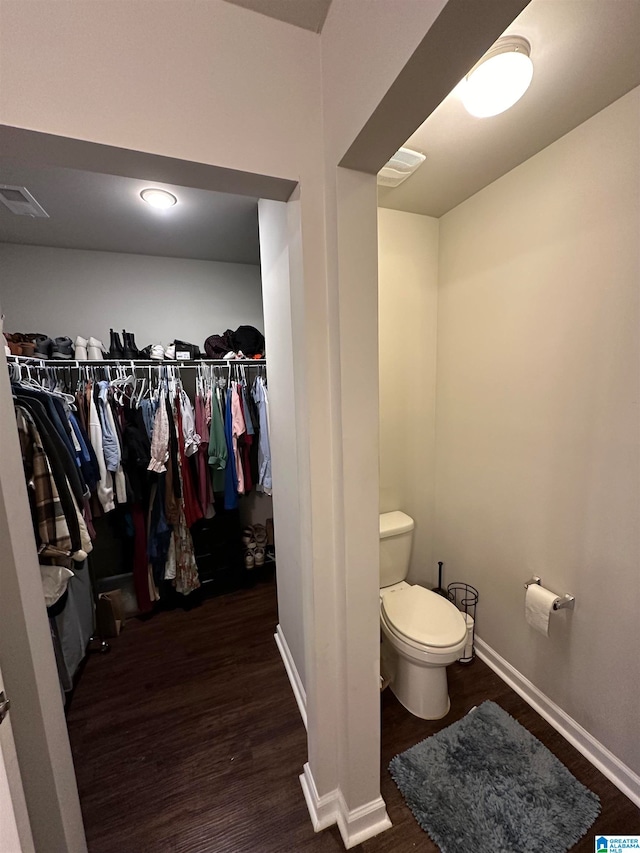 bathroom with hardwood / wood-style flooring and toilet