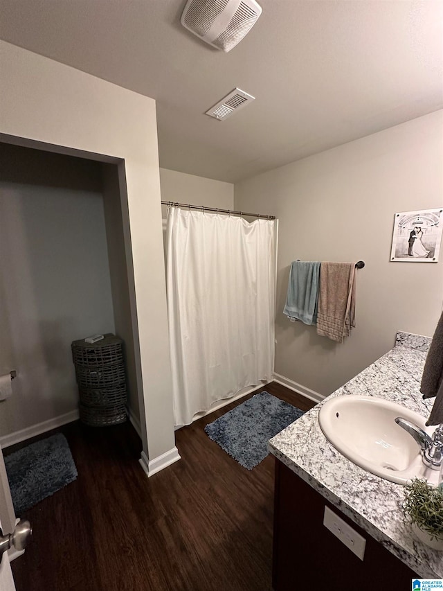 bathroom featuring vanity and wood-type flooring