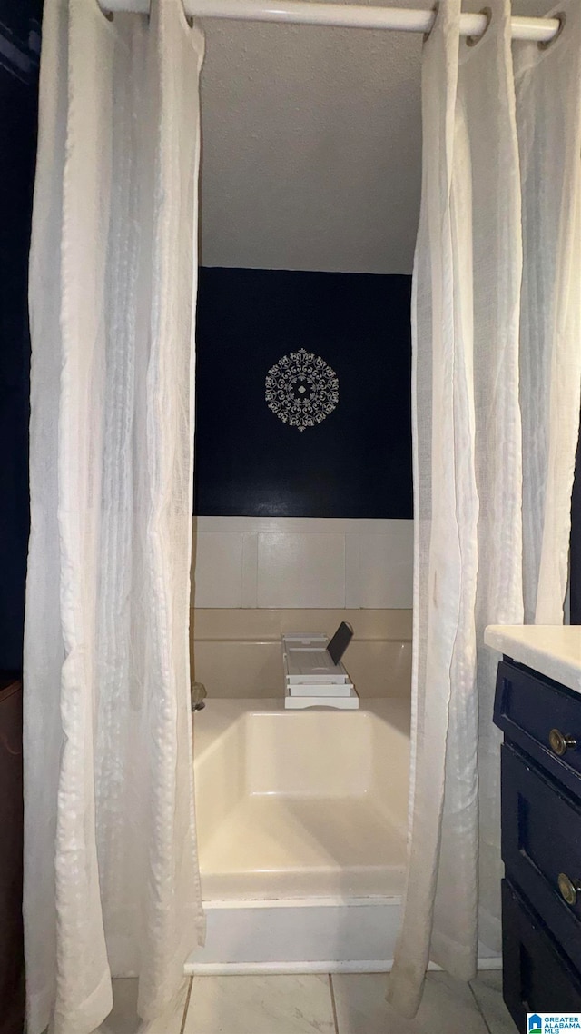 bathroom featuring vanity and a shower with shower curtain