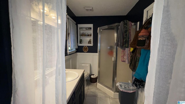 bathroom with vanity, tile patterned floors, and a shower with door