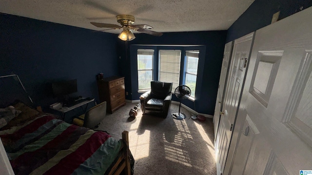 bedroom featuring ceiling fan, carpet flooring, and a textured ceiling