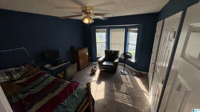 carpeted bedroom with ceiling fan and a textured ceiling