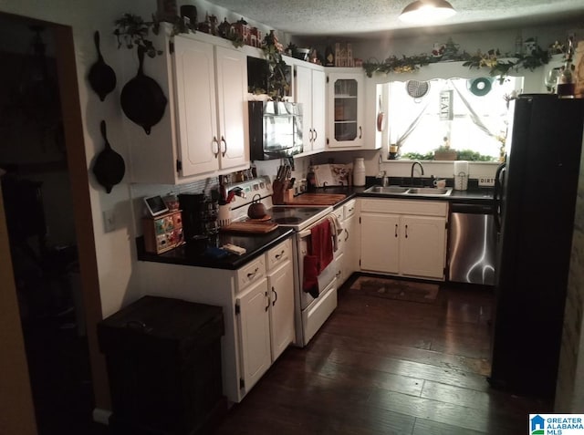 kitchen with white cabinetry, white electric range oven, stainless steel dishwasher, sink, and black fridge