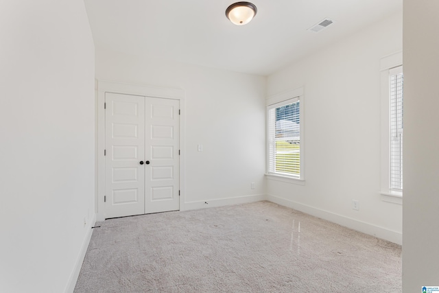 empty room with light colored carpet