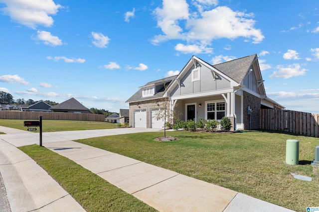 view of front of property featuring a front yard and a garage