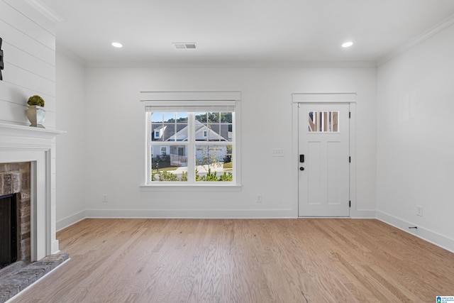 unfurnished living room featuring crown molding and light hardwood / wood-style floors