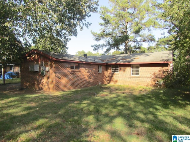 rear view of house featuring a yard