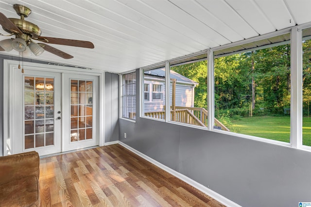 unfurnished sunroom with ceiling fan, french doors, and a wealth of natural light