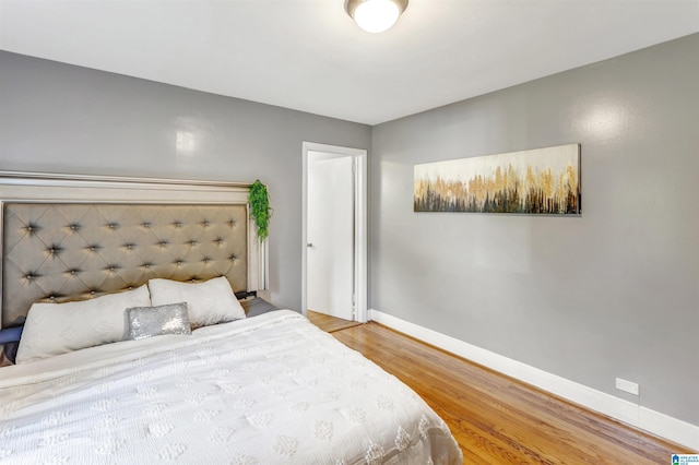 bedroom with wood-type flooring