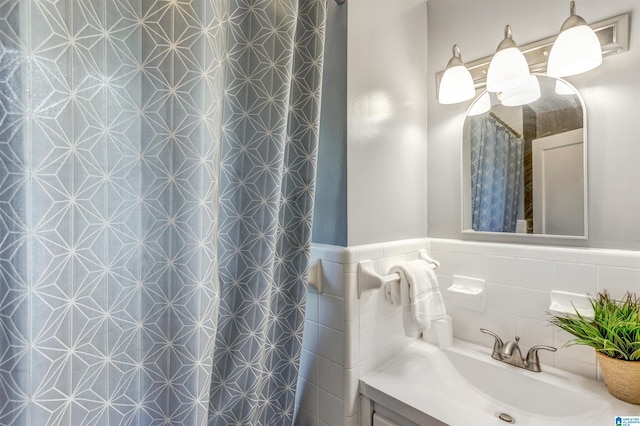 bathroom featuring tile walls and vanity