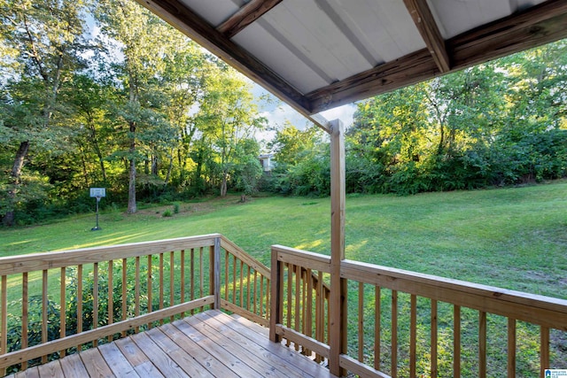 wooden terrace featuring a lawn