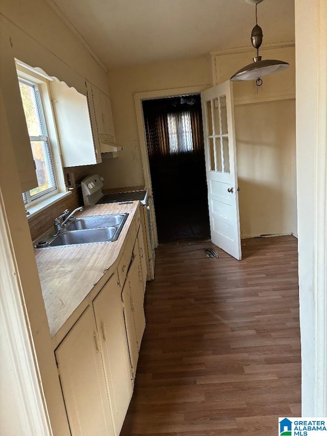 kitchen featuring white cabinetry, range, sink, and dark hardwood / wood-style flooring