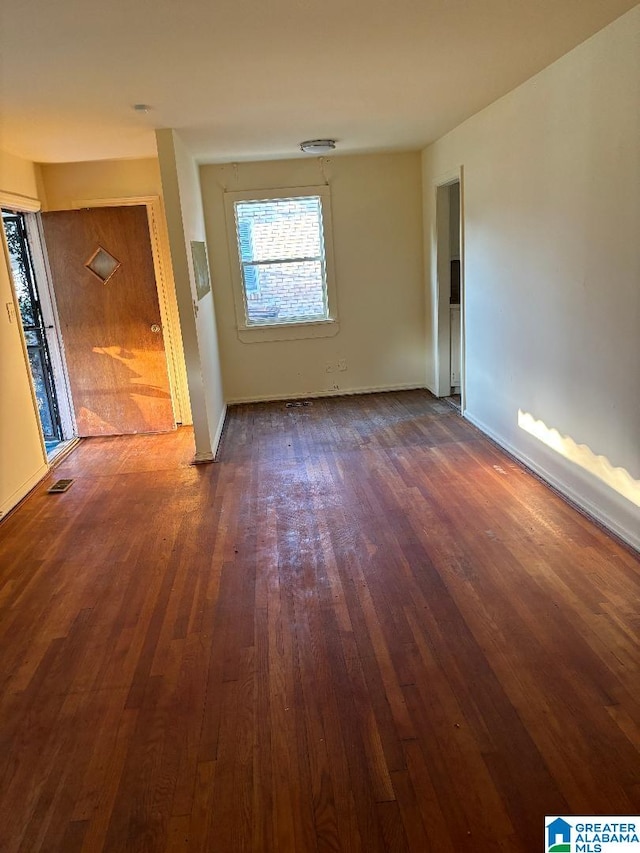 spare room featuring dark wood-type flooring