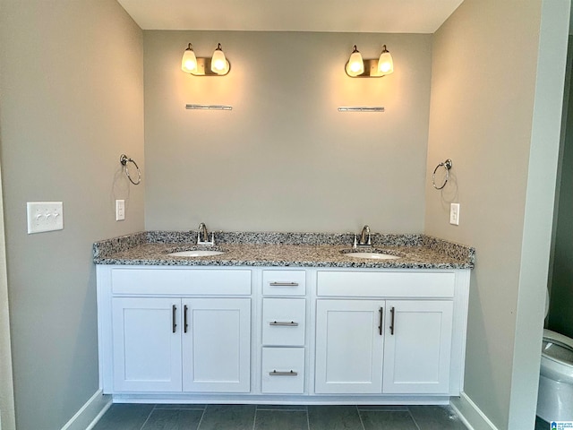 bathroom featuring tile patterned flooring, vanity, and toilet