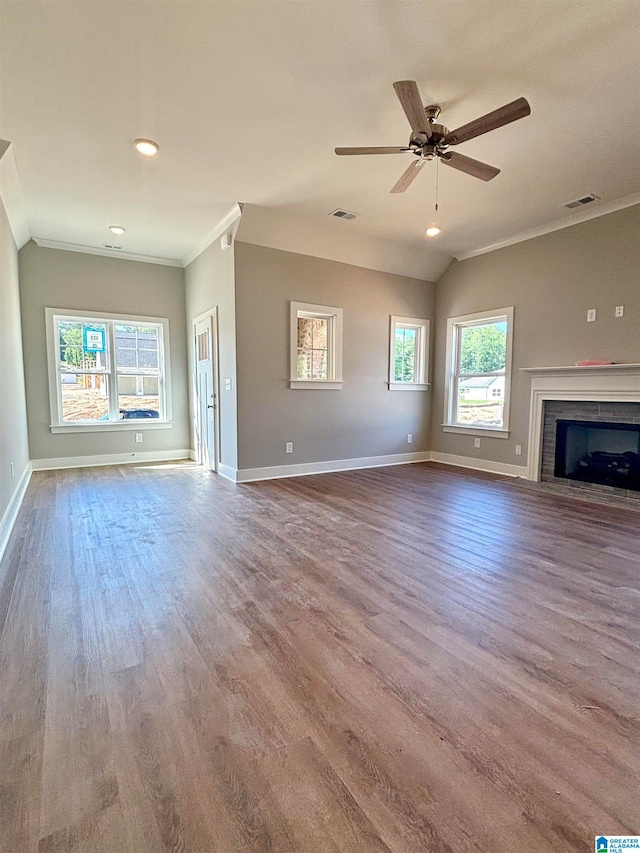 unfurnished living room with ceiling fan, vaulted ceiling, hardwood / wood-style flooring, and ornamental molding