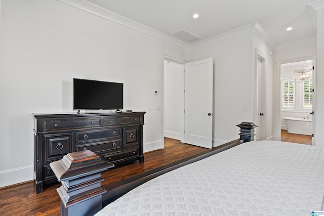 bedroom featuring connected bathroom, dark hardwood / wood-style floors, and crown molding