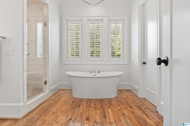 bathroom featuring independent shower and bath and wood-type flooring