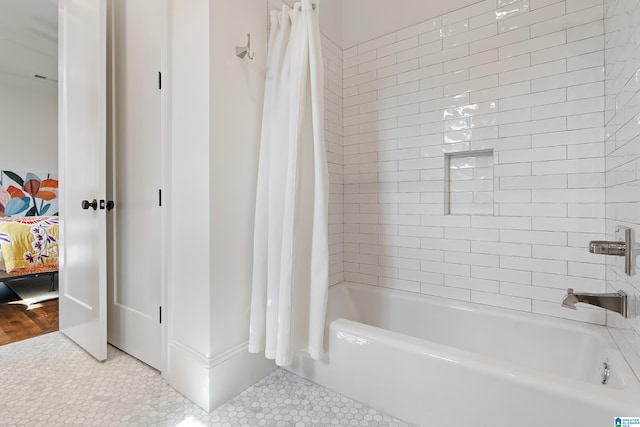 bathroom with shower / tub combo with curtain and tile patterned flooring