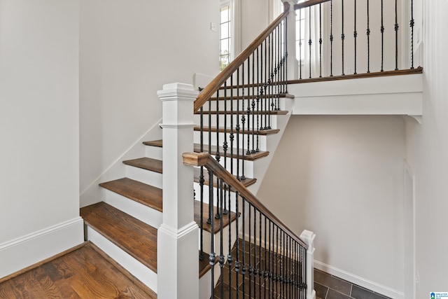 stairway with hardwood / wood-style floors