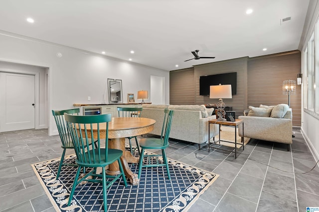 dining area with ornamental molding and ceiling fan