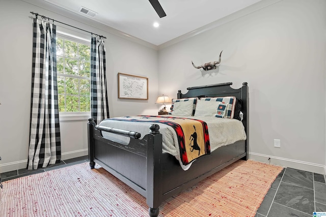 tiled bedroom with ornamental molding and ceiling fan