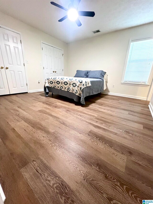 bedroom featuring wood-type flooring and ceiling fan