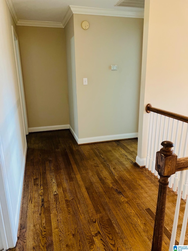 hall with ornamental molding and dark wood-type flooring