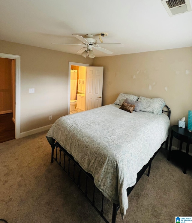 bedroom featuring dark colored carpet, connected bathroom, and ceiling fan