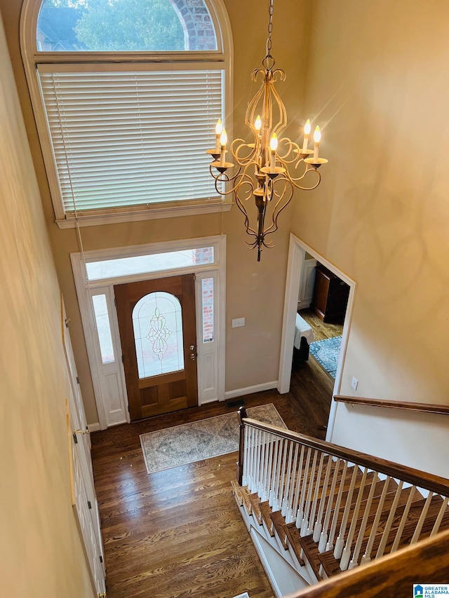 foyer with a notable chandelier, a high ceiling, and dark hardwood / wood-style flooring