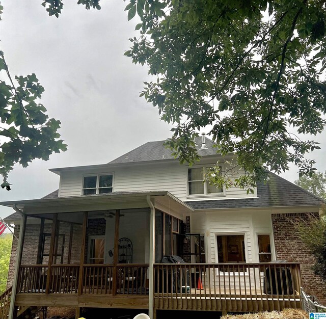 rear view of property with a sunroom