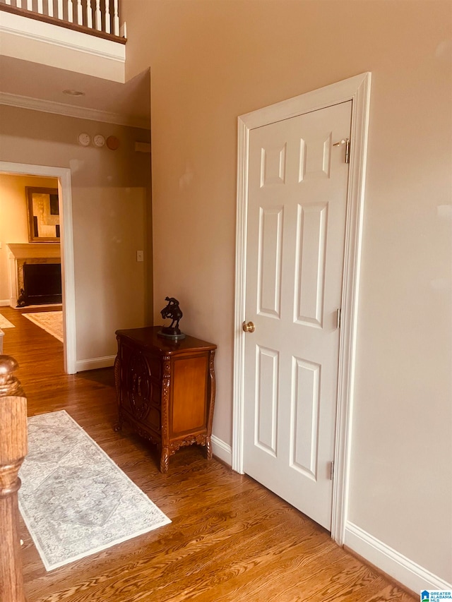 hallway featuring crown molding and wood-type flooring