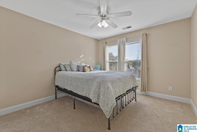 bedroom with ceiling fan and light carpet